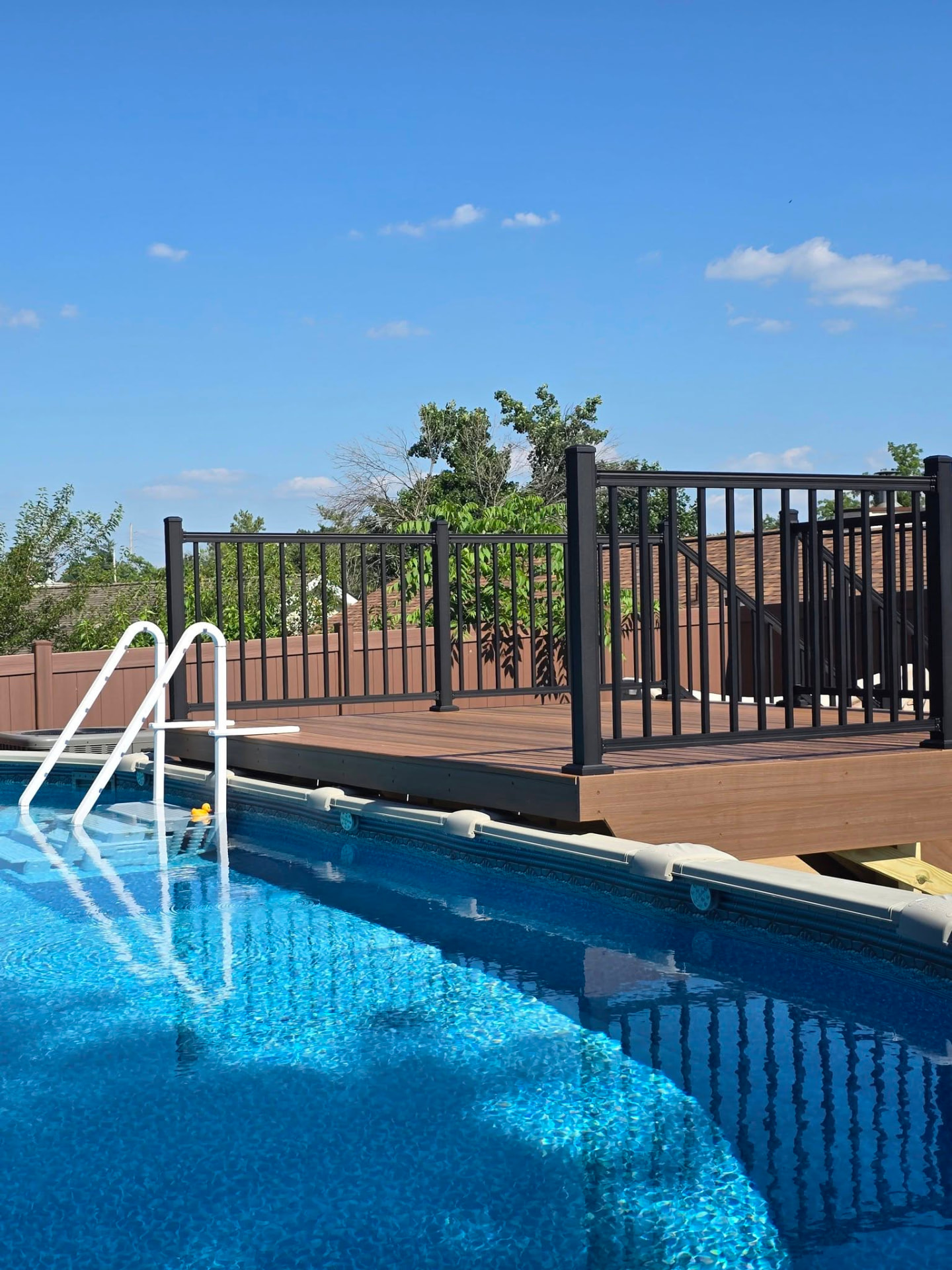 Maintenance-free Envision Spiced Teak pool deck by B&R Construction