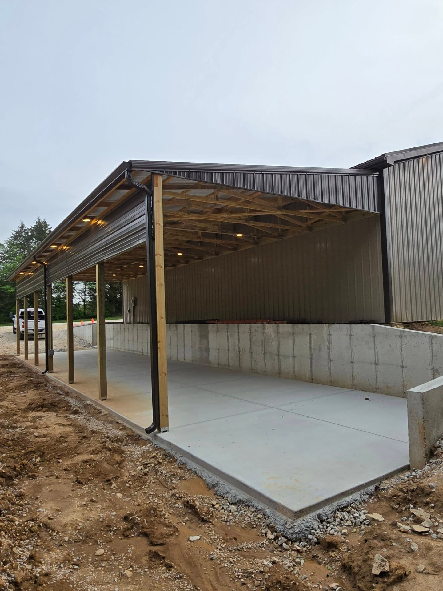 Open trusses and can lights under the 60' × 20' lean-to by B&R Construction