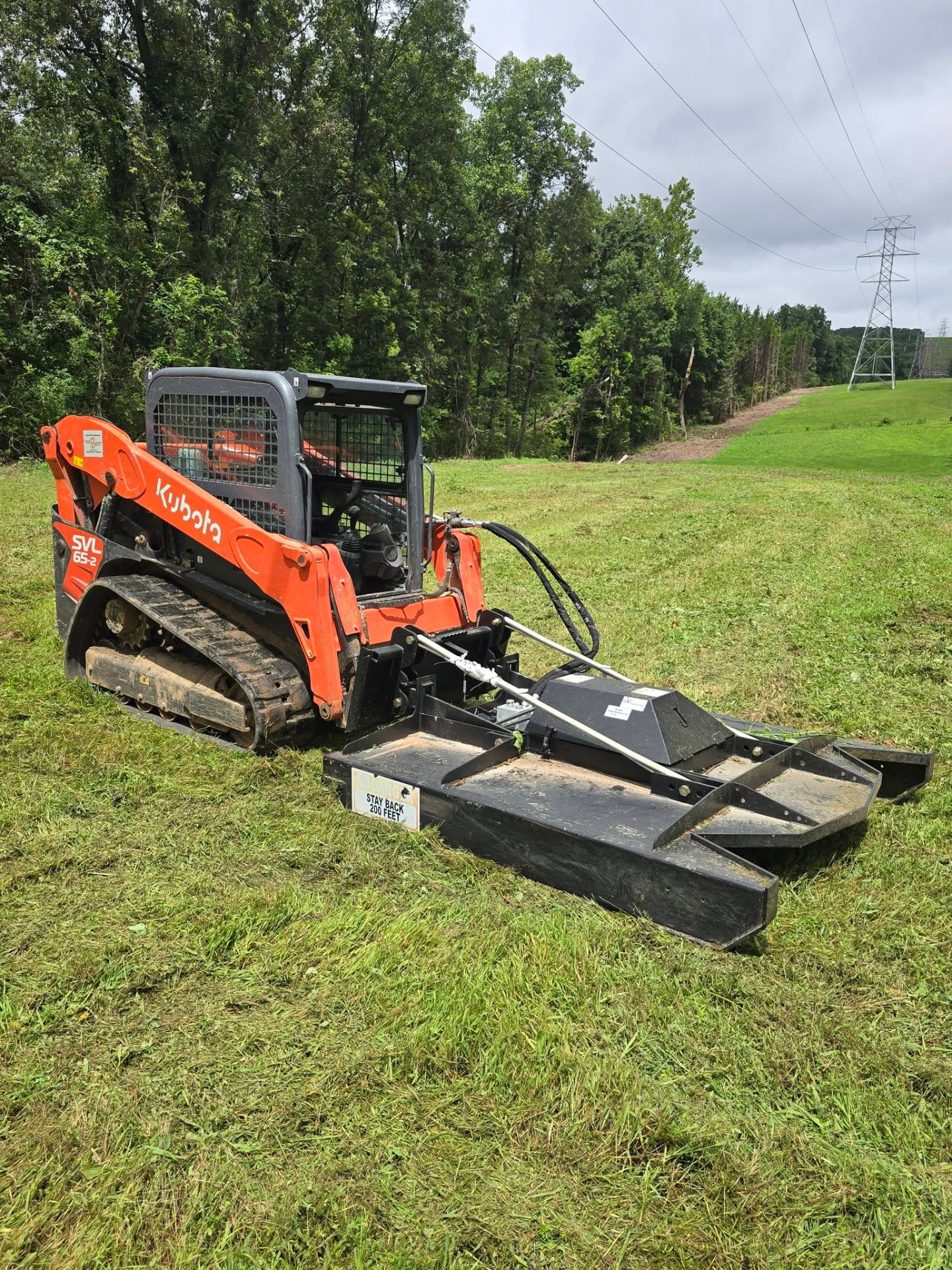 Our Kubota track loader with the brush cutter attachment — it mulches anything up to a 5" tree, so we can clear fields, pond dams, and ditch lines a tractor can't reach by B&R Construction