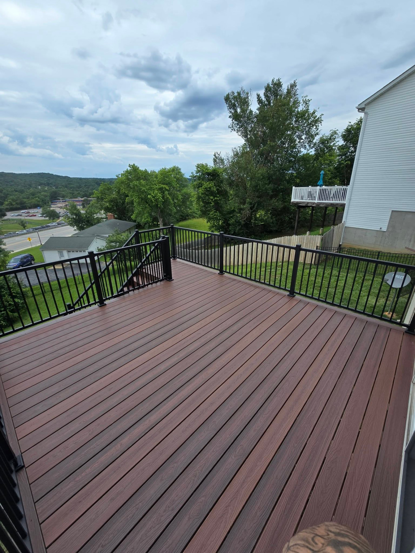 Envision Shaded Auburn deck with black aluminum handrails by B&R Construction