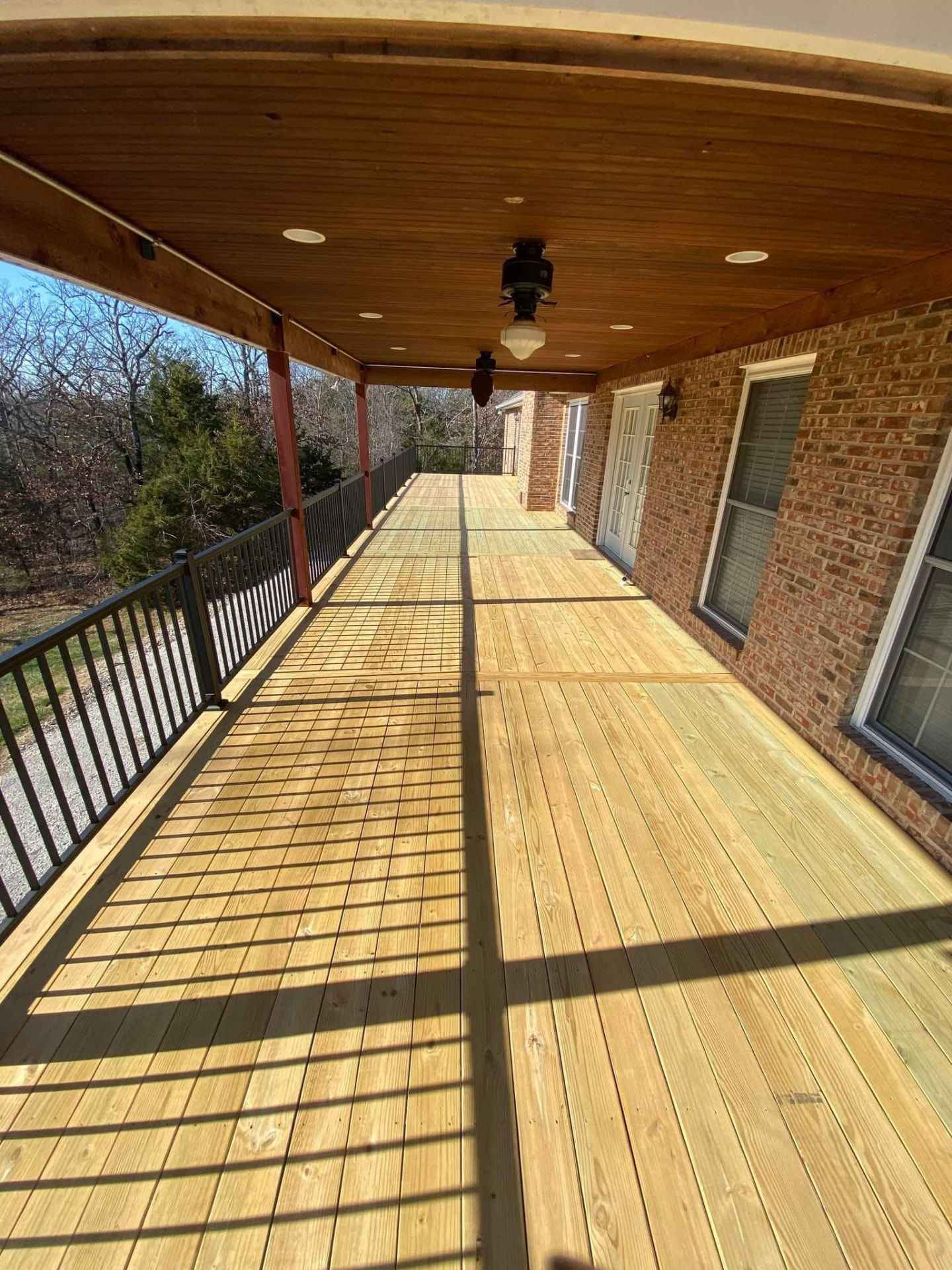 New band board and treated framing under the covered porch on the resurfaced deck by B&R Construction