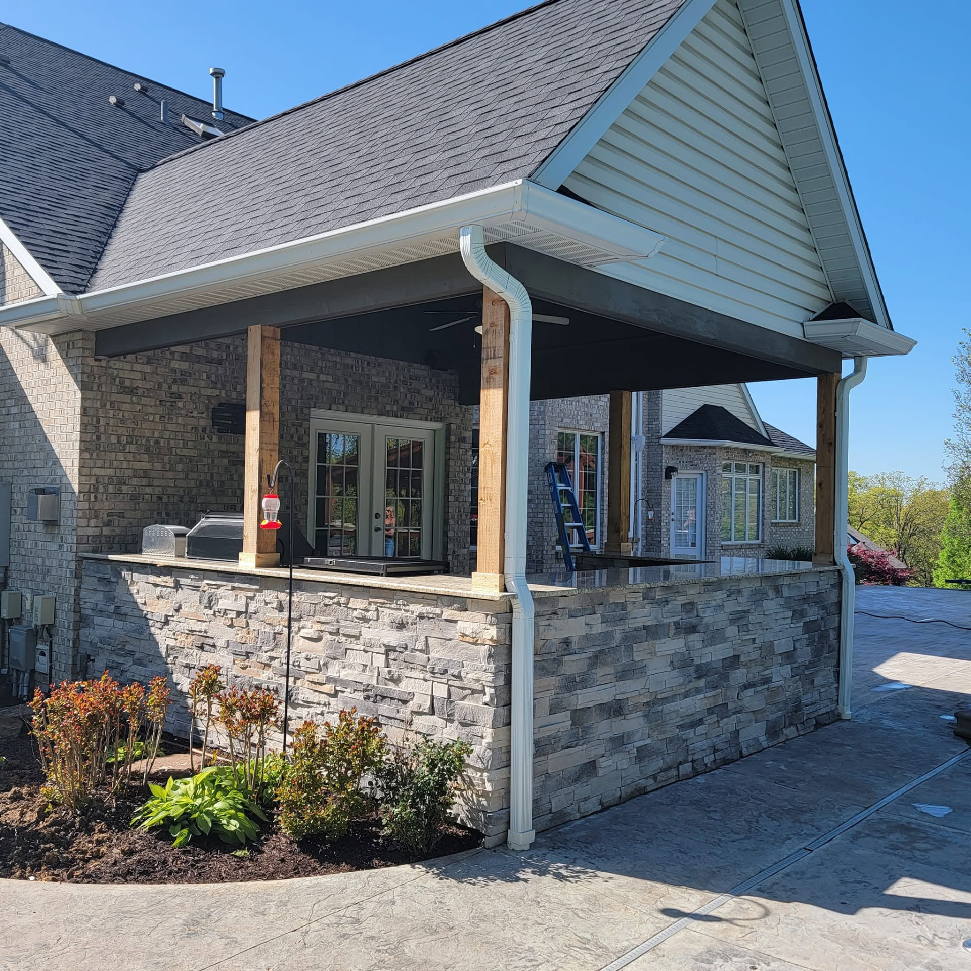 All-stainless cabinets, drawers, and doors with granite countertops and a stone finish built to withstand Missouri weather by B&R Construction