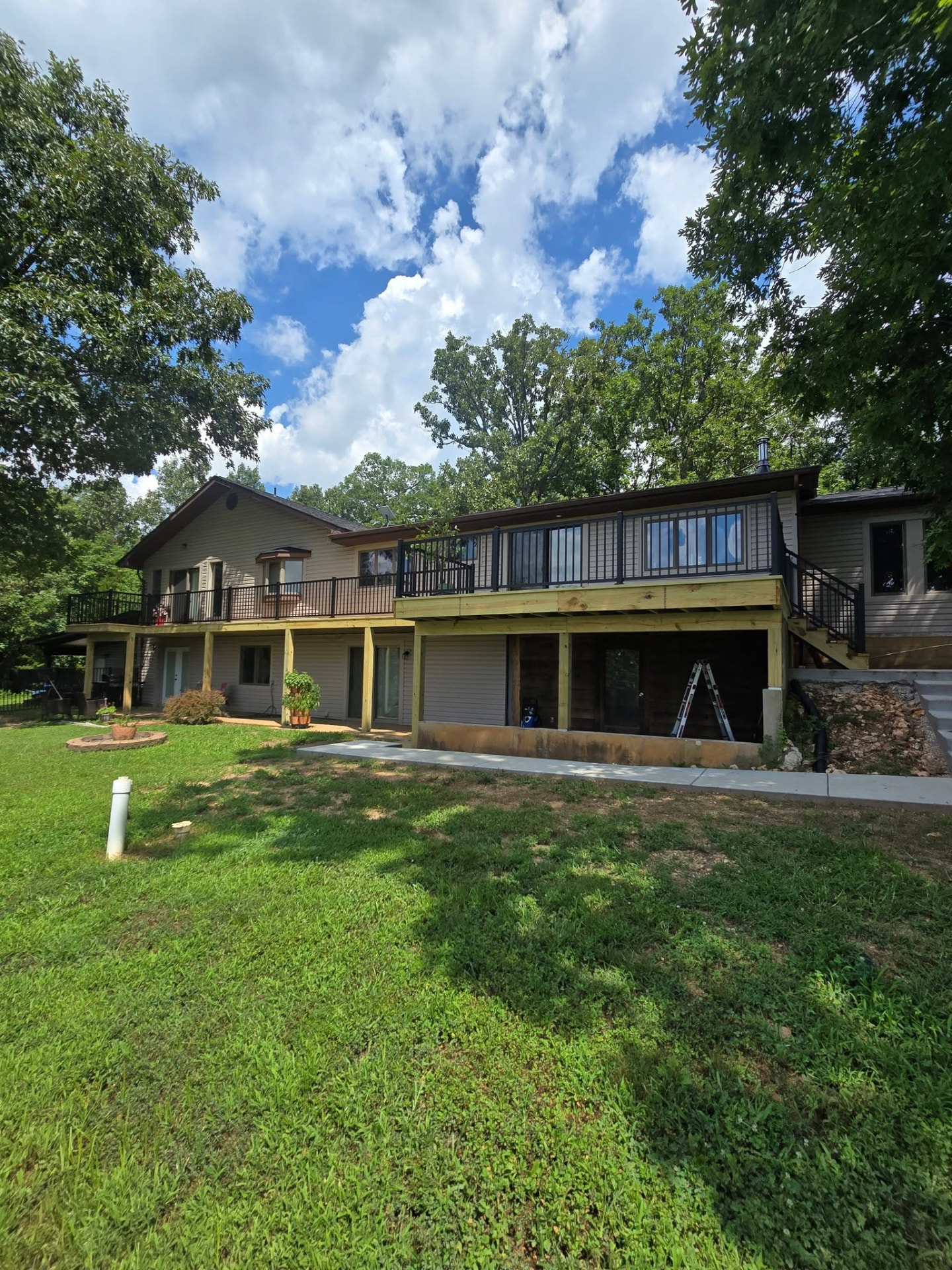 The rebuilt 60' treated deck on the back of the house, viewed from the yard by B&R Construction