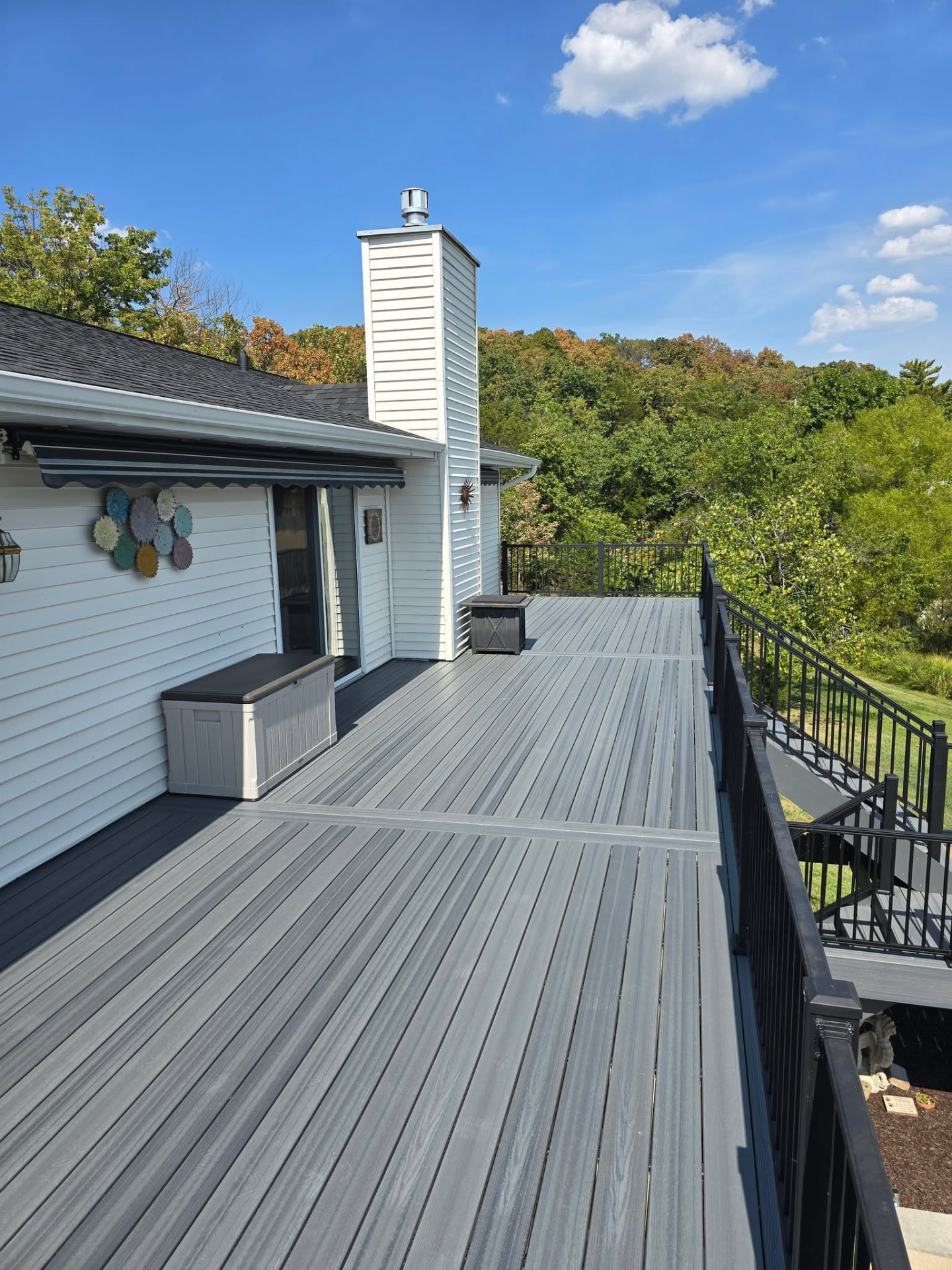 Graywood composite boards with double divider boards and black aluminum handrails on the 50' × 12' deck by B&R Construction
