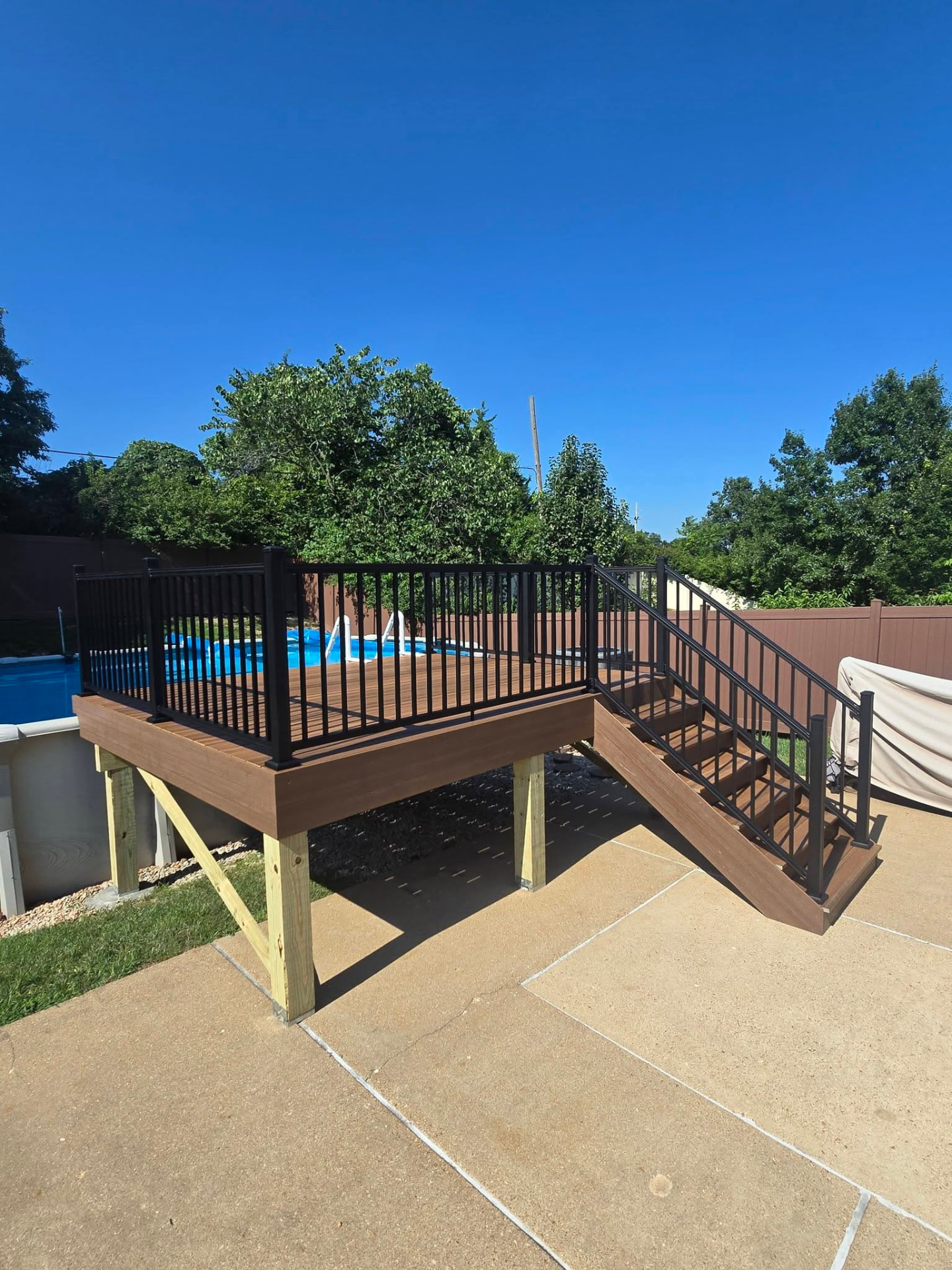 Demo and rebuild of a 12 × 10 maintenance-free Envision Spiced Teak pool deck by B&R Construction