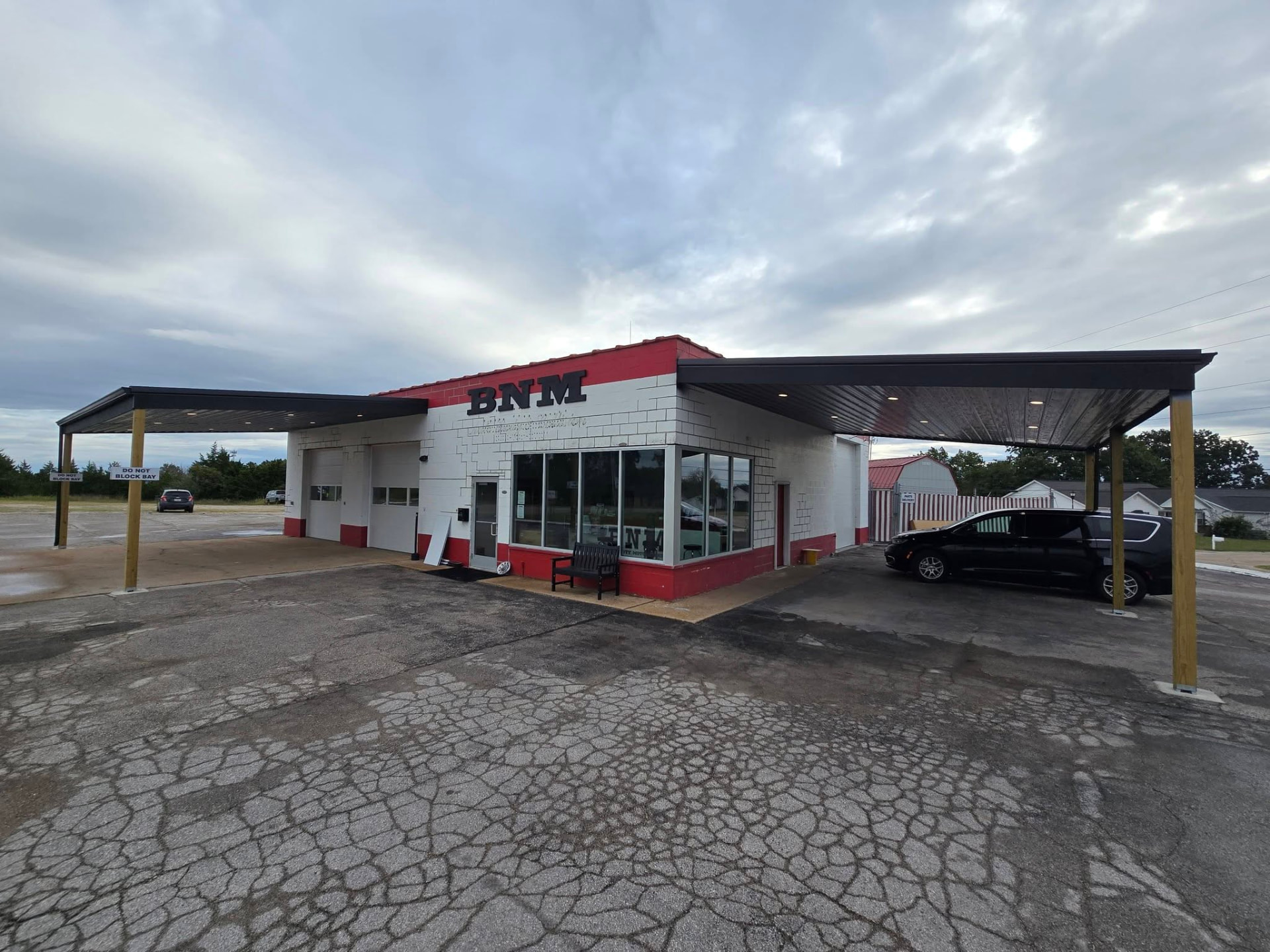 Two 30' × 20' lean-tos added to the BNM Auto Body & Collision building in Hillsboro — shade and weather cover for the office, estimating, and detailing by B&R Construction in Hillsboro, MO