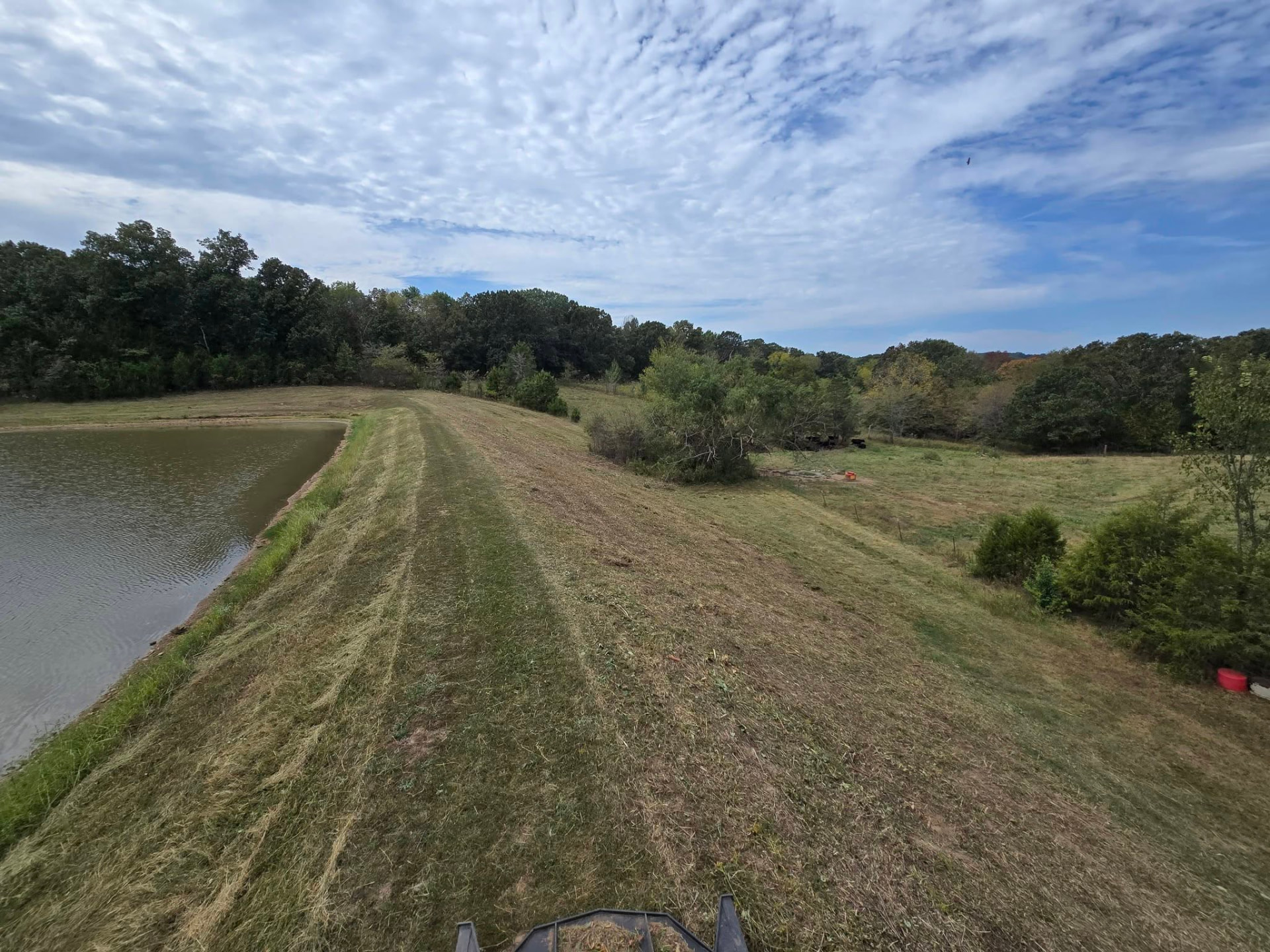 Land clearing on a pond bank — brush and growth cleared back to open up the water's edge by B&R Construction