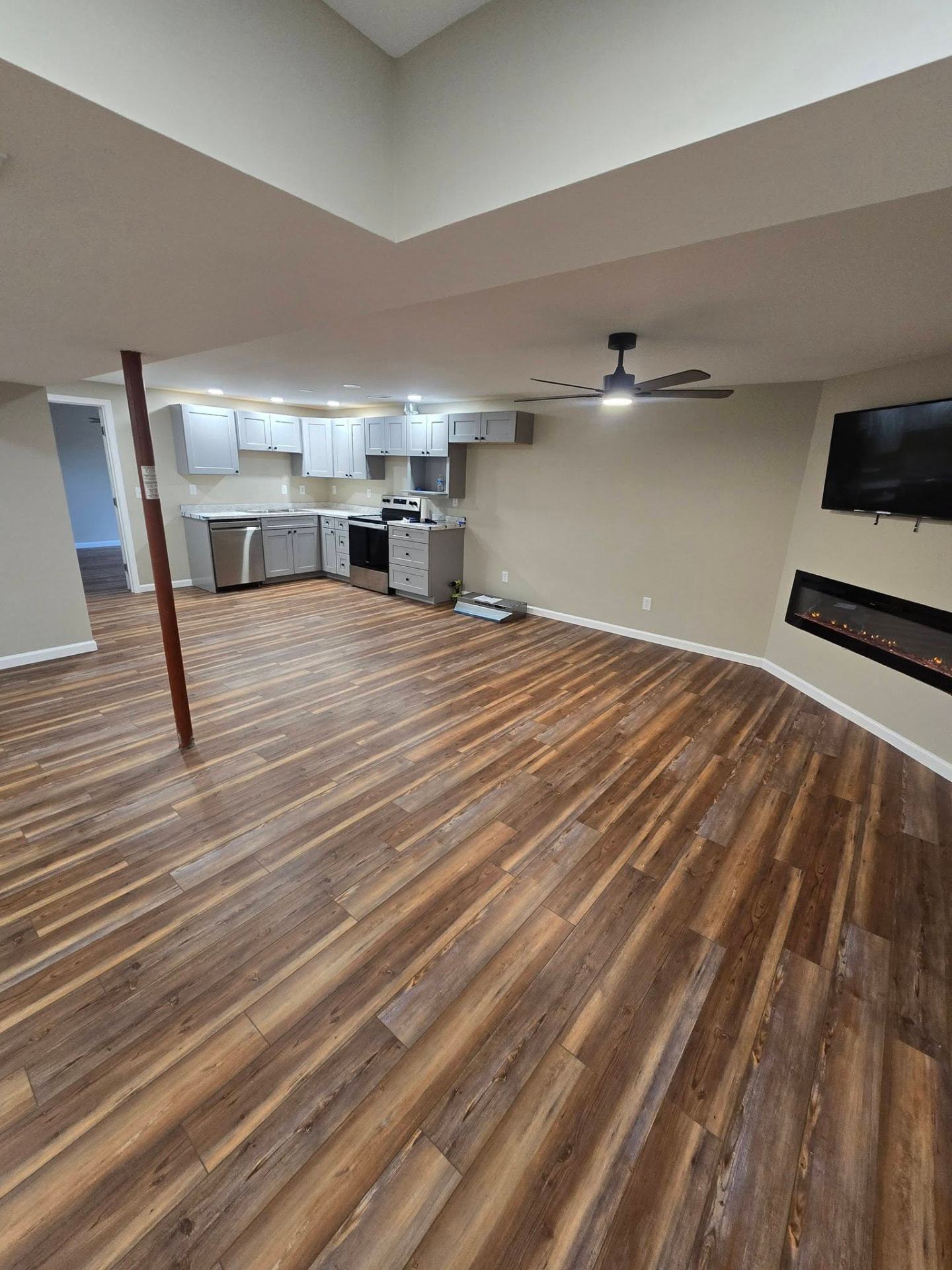 900 sq ft basement finish — living room with kitchenette, 1 bedroom, 1 bathroom, and an oversized closet/laundry room by B&R Construction