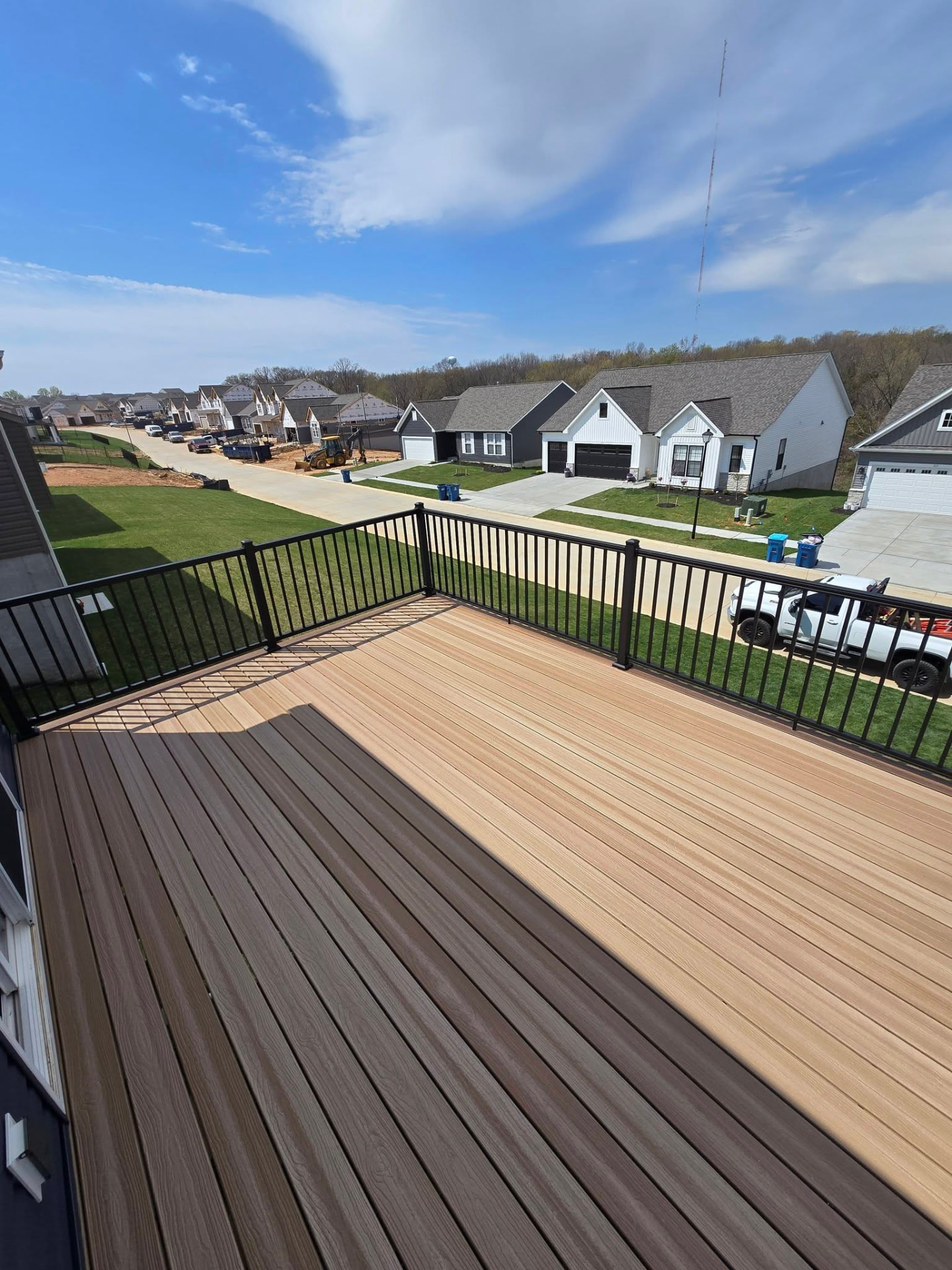 New construction — 16' × 12' composite deck with a Rustic Walnut picture-frame border and Hampton Dunes center by B&R Construction