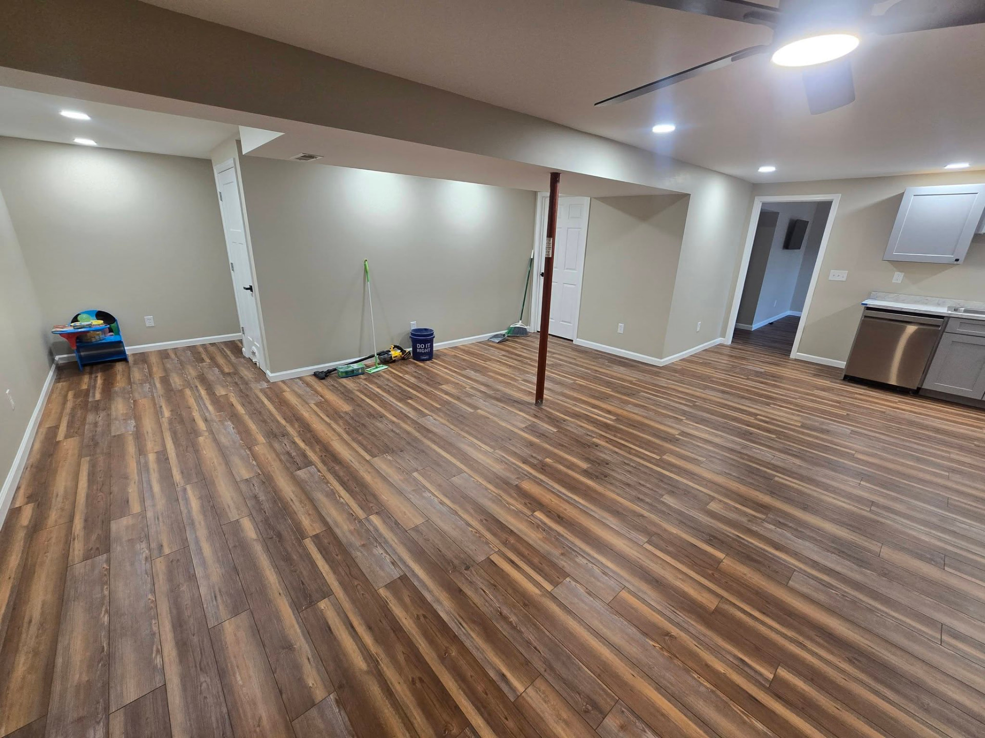 Open living area with kitchenette and gas fireplace in the 900 sq ft basement finish by B&R Construction