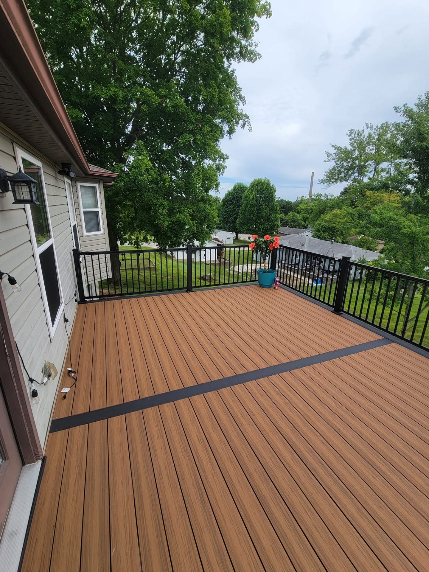 Complete demo and rebuild — 20' × 14' maintenance-free Decorators decking in Sedona with a slate picture-frame border and skirt boards by B&R Construction